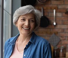a woman smiling with dentures at home