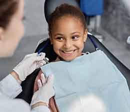 Girl smiling in the dental chair