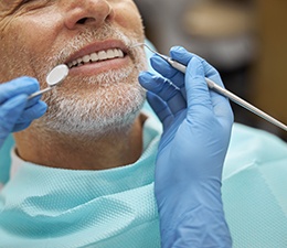 a man rinsing his mouth in a bathroom