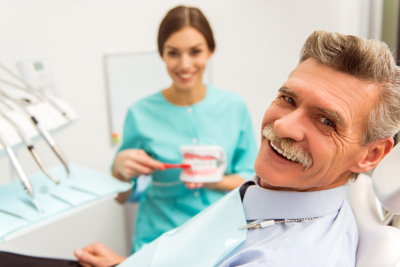 Denture patient smiling at their dental visits